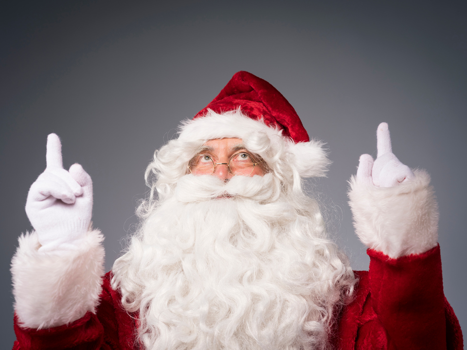 Santa Claus with hands showing the upper direction