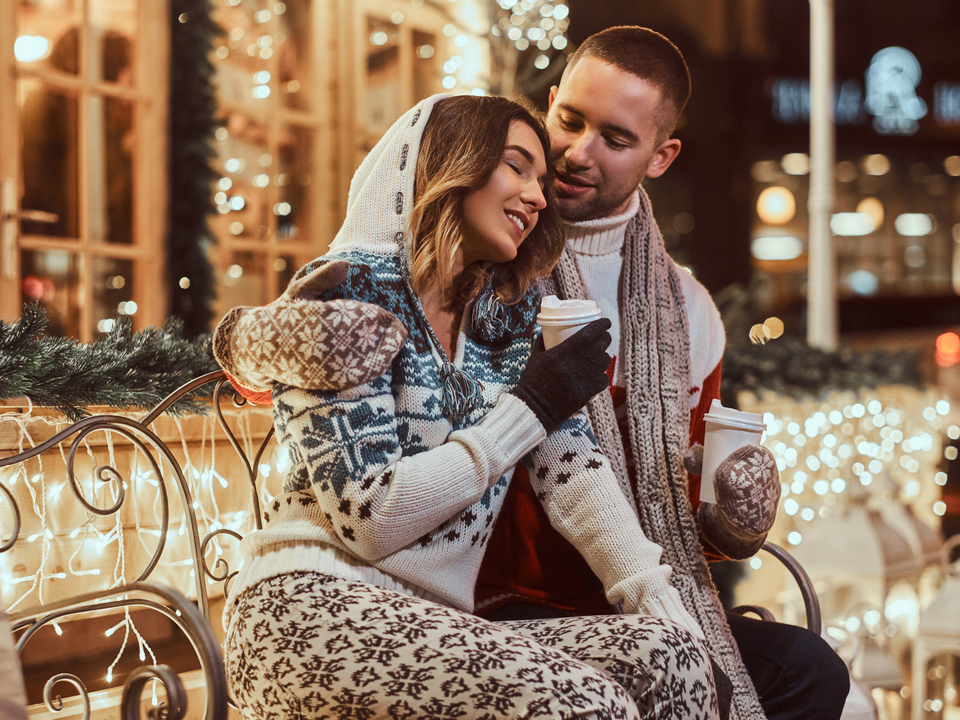 Young romantic couple at Christmas time, enjoying spending time together